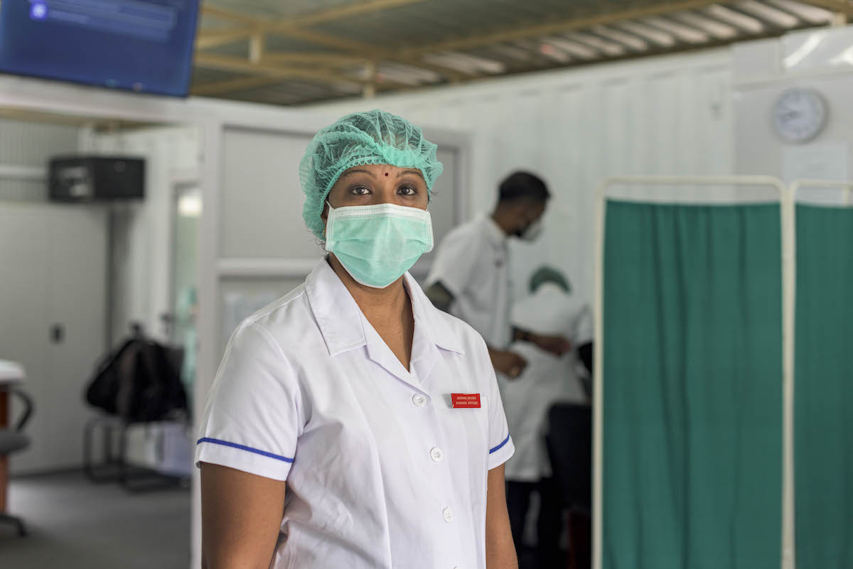Female health worker in medical mask and haircover Female health worker in medical mask and haircover