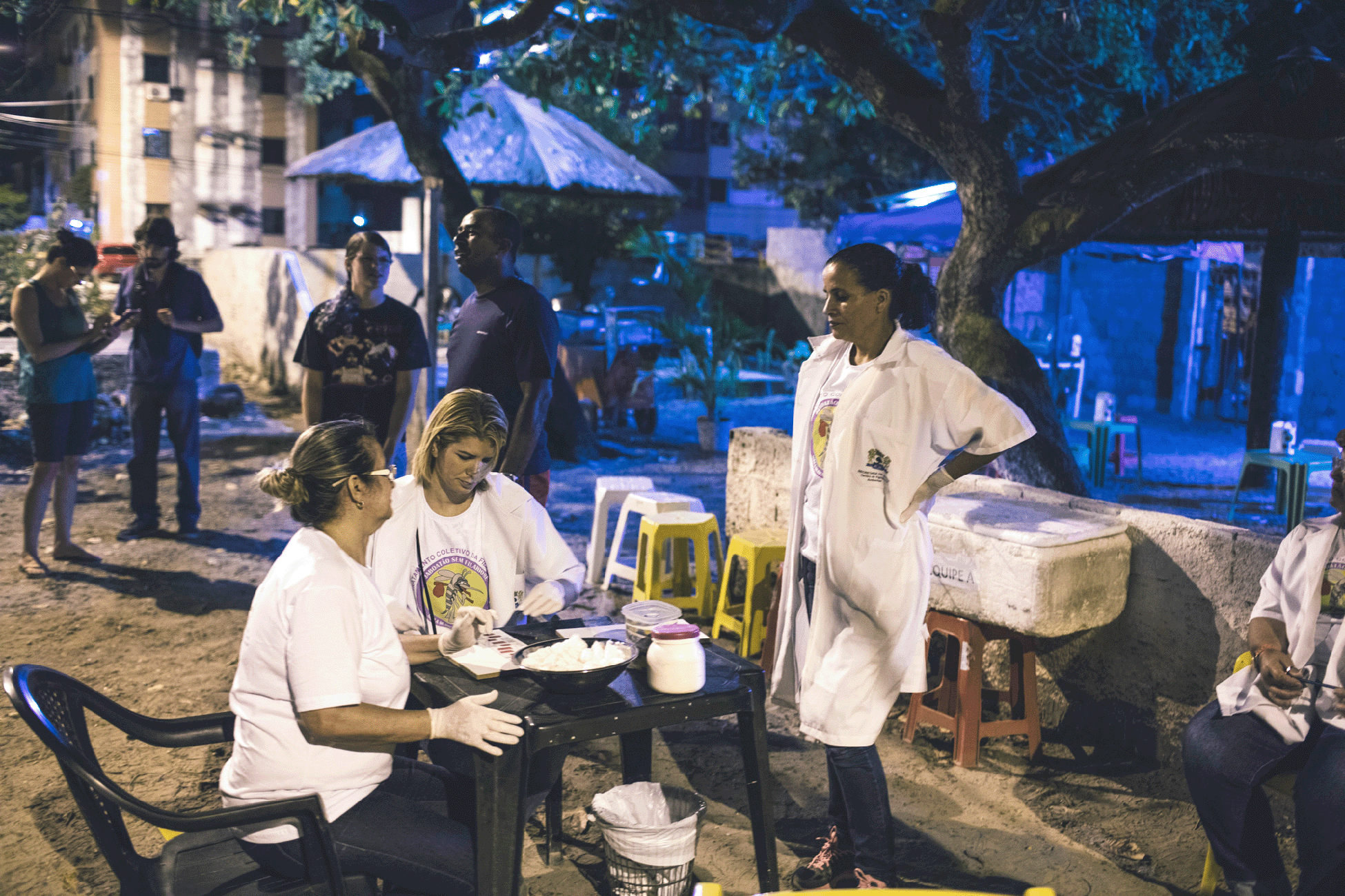 Joshua E. Cogan-Pernambuco Brazil microfilaria testing for lymphatic filariasis Health-care workers sitting at and standing round a table in an outdoor setting
