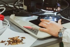 stereo-microscope scientist  examining samples through stereo-microscope.