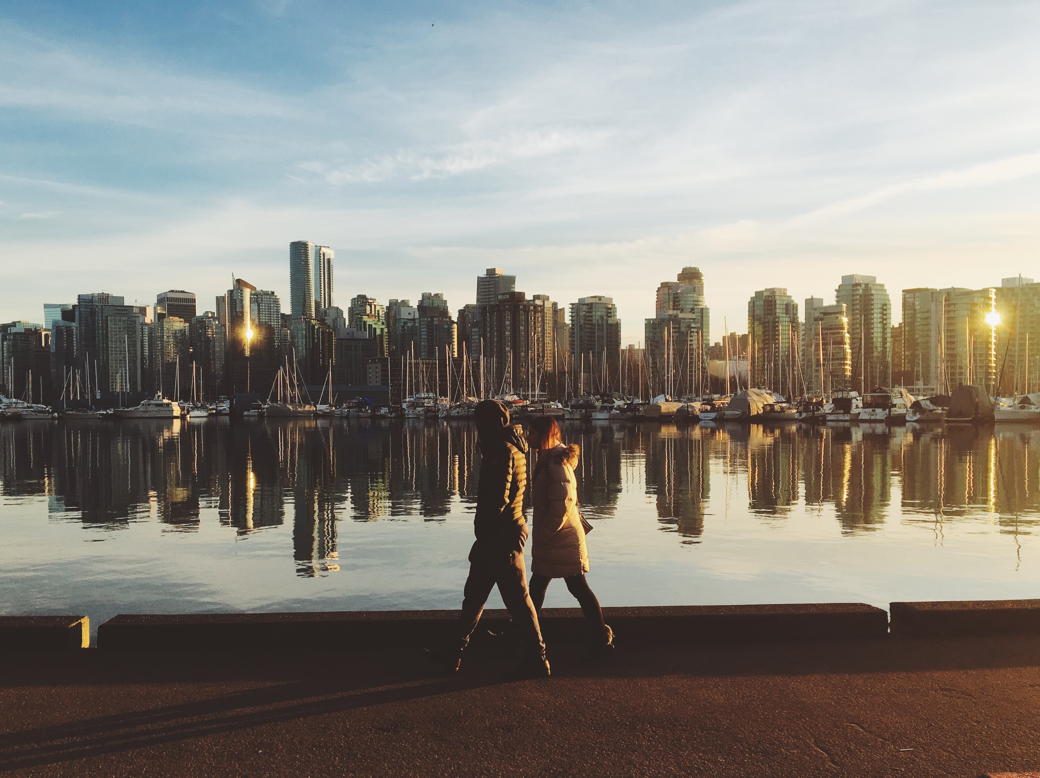 urban_planning_landing_page two people walking by river with city skyline