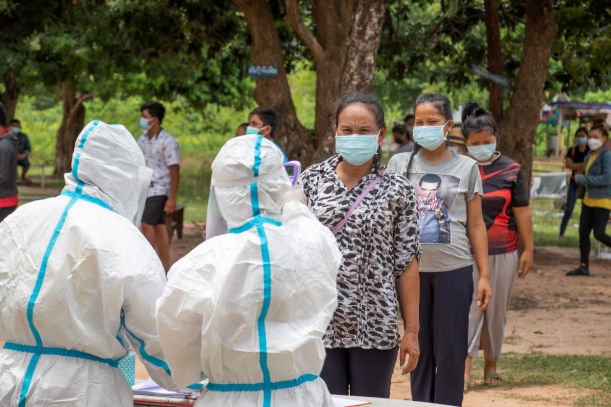 Healthcare staff conducting temperature checks Temperature checks are done twice a day, usually when the returnees collect their meals
