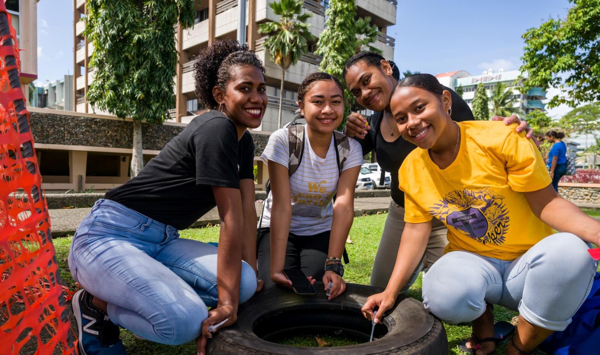 WP47950 Four adolescent girls sit next to a mosquito larvae collection site in Fiji